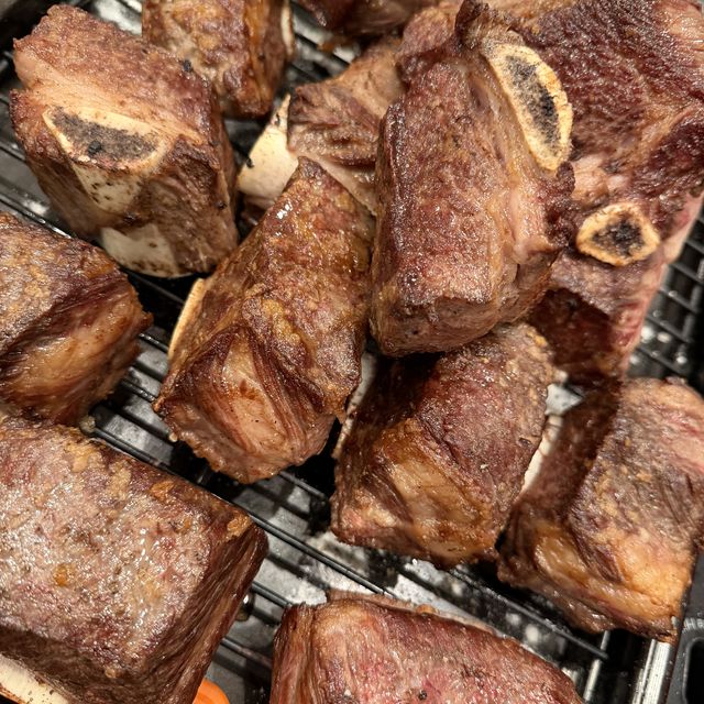Seared bone-in short ribs on a rack, ready to braise