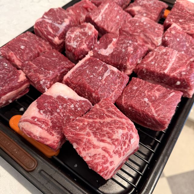 Raw, well-marbled English-cut short ribs on a rack