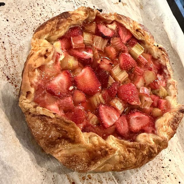 Baked strawberry rhubarb galette with a golden, flaky puff pastry crust